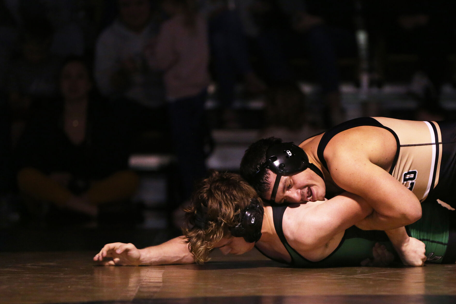 Ruben Cleveland pushes down on Kelly Walsh sophomore Logan Evenson